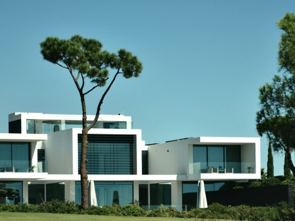 a large white building with a tree in front of it