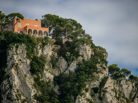 A house on top of a mountain surrounded by trees