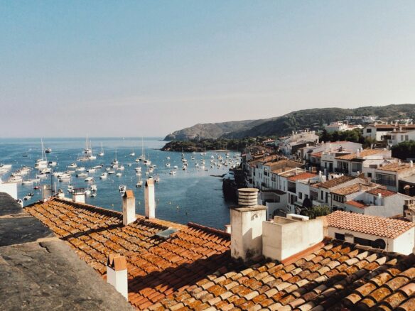 white boat lot on sea beside mountain