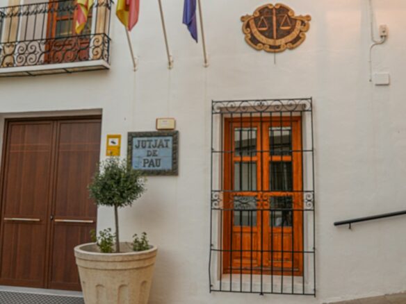 a door with a gate and a planter with flags on it