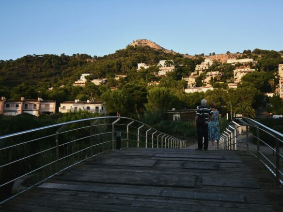 a couple of people that are standing on a bridge