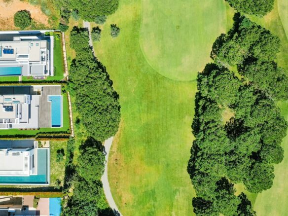 an aerial view of a golf course with houses