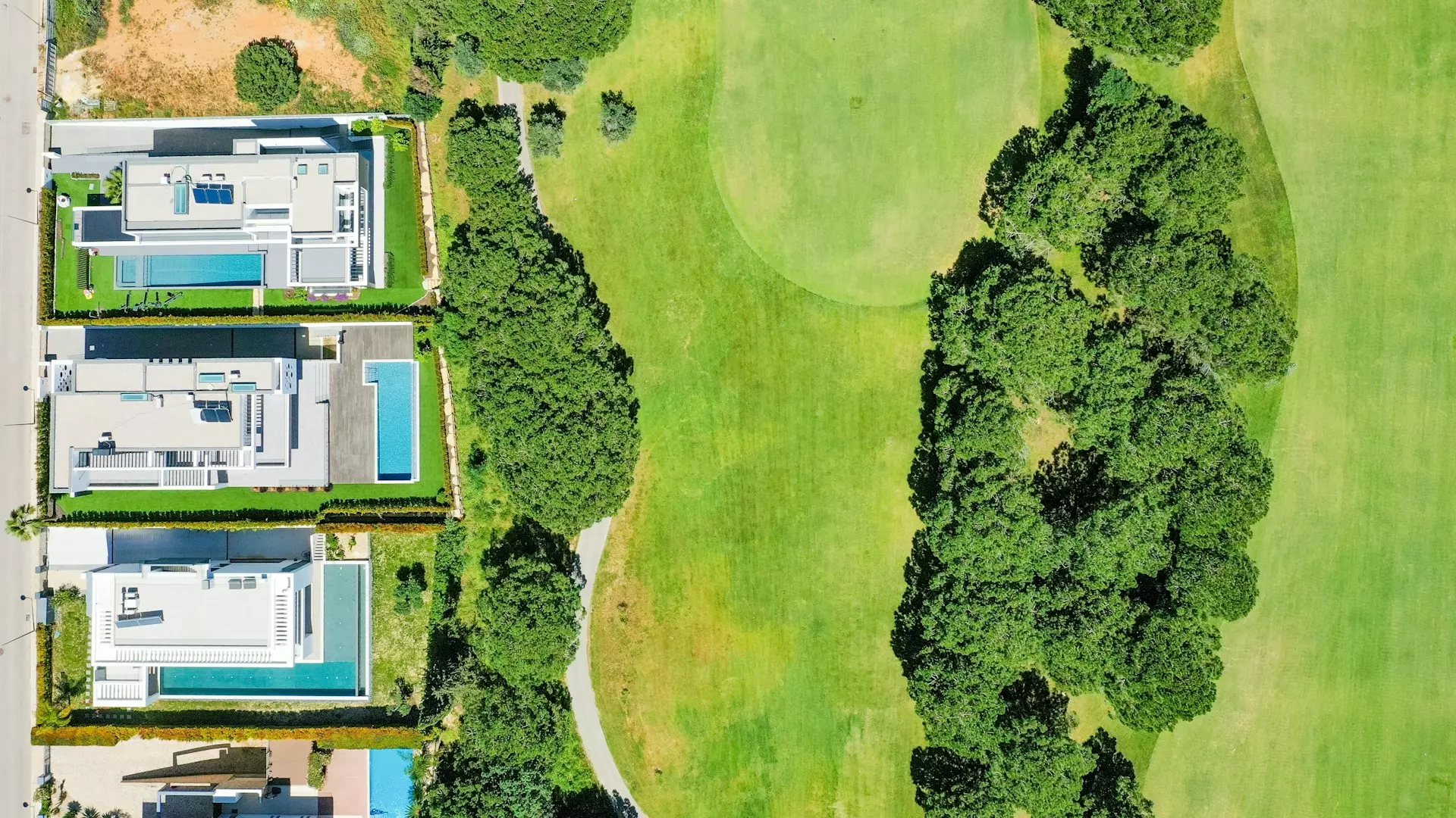 an aerial view of a golf course with houses