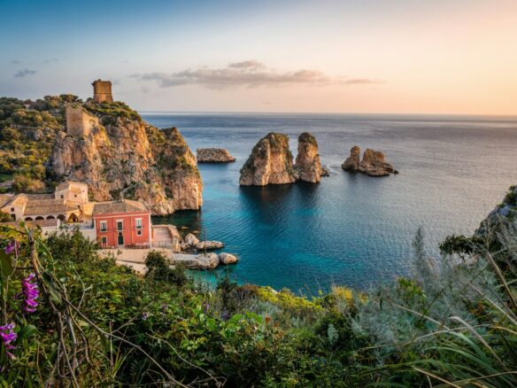 photo of house near cliff and body of water