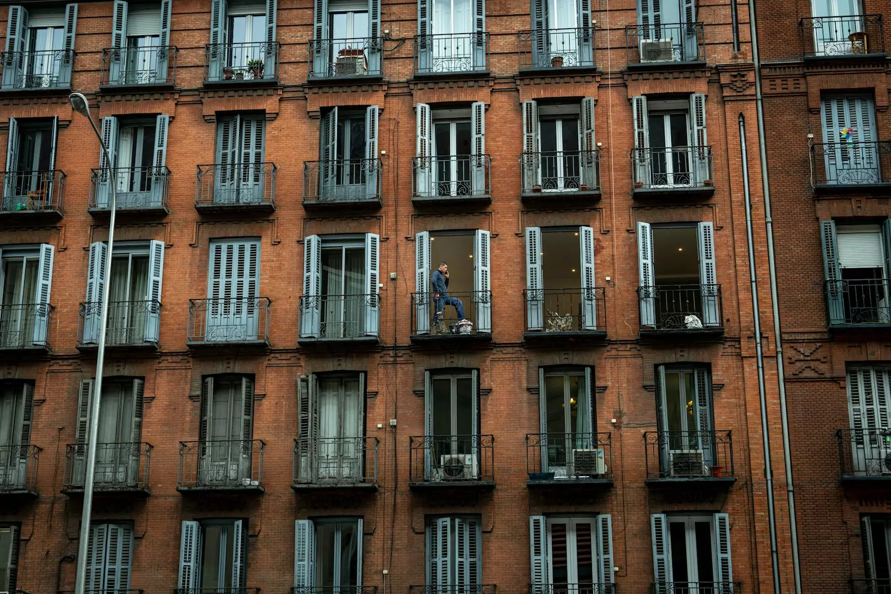 a tall building with lots of windows and balconies