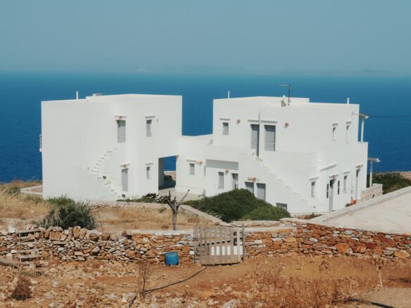White buildings stand near the sea.