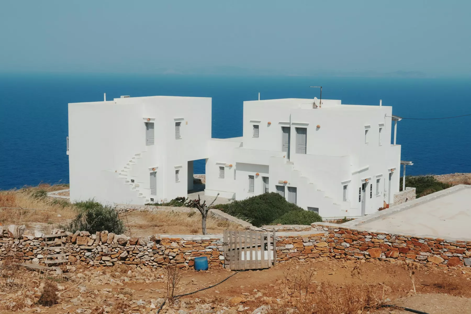 White buildings stand near the sea.
