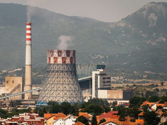 a factory with smoke coming out of it's stacks