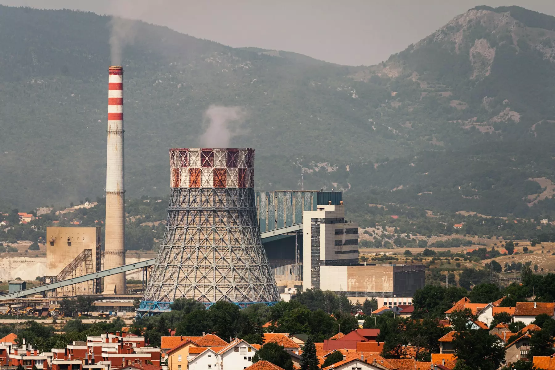 a factory with smoke coming out of it's stacks