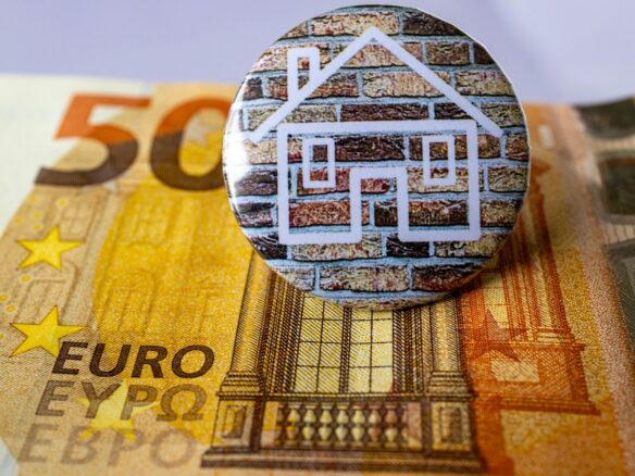 a button sitting on top of a pile of money