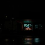 a neon sign is lit up in the dark