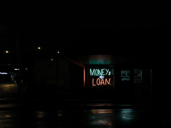 a neon sign is lit up in the dark