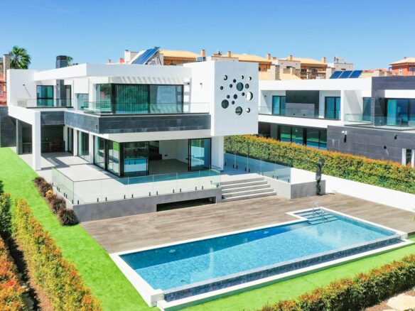 a large white house with a pool in front of it