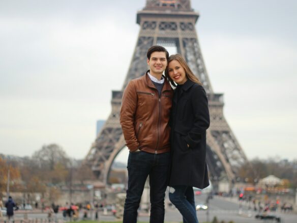woman and man standing behind of Eiffel Tower