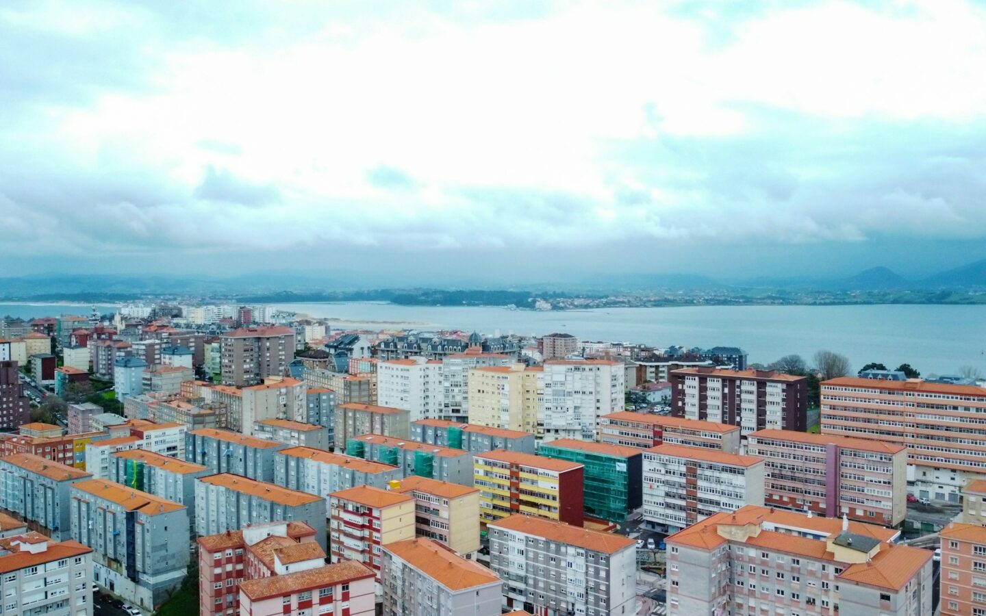 a view of a city with a body of water in the background