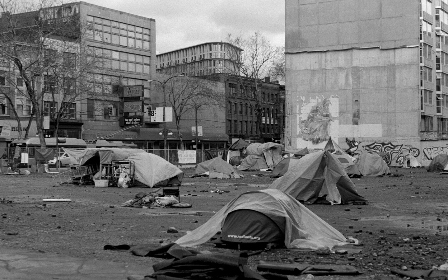 a black and white photo of a homeless camp site
