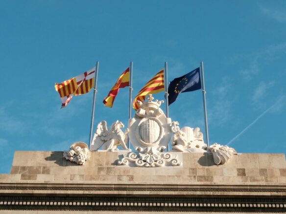 A group of flags flying on top of a building