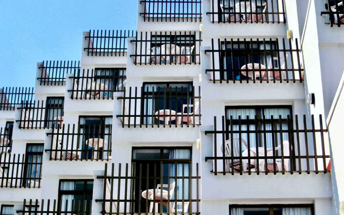 a tall white building with balconies and balconies on the balcon