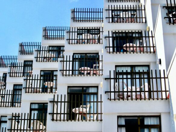 a tall white building with balconies and balconies on the balcon