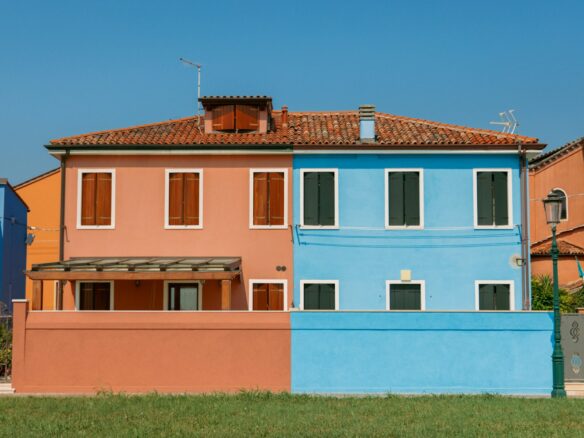 a blue and pink house next to each other