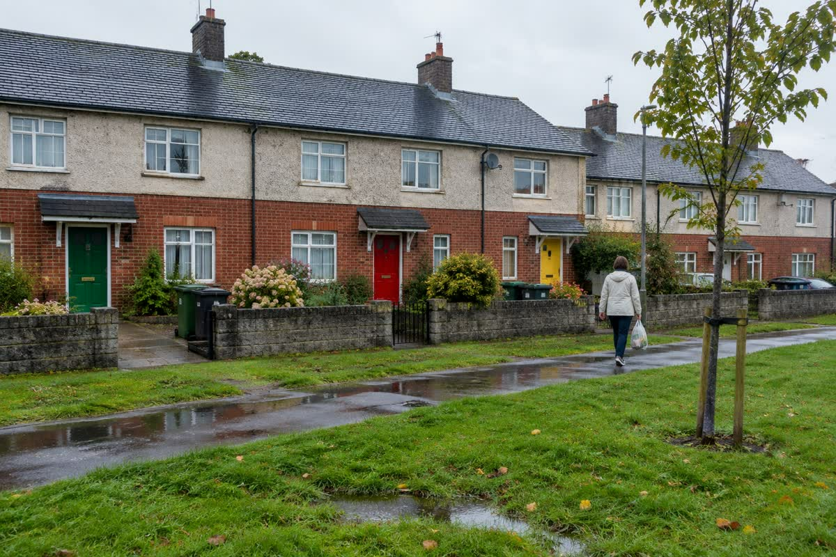 Mid-rise apartment blocks around a green in a Dublin suburb (illustration)