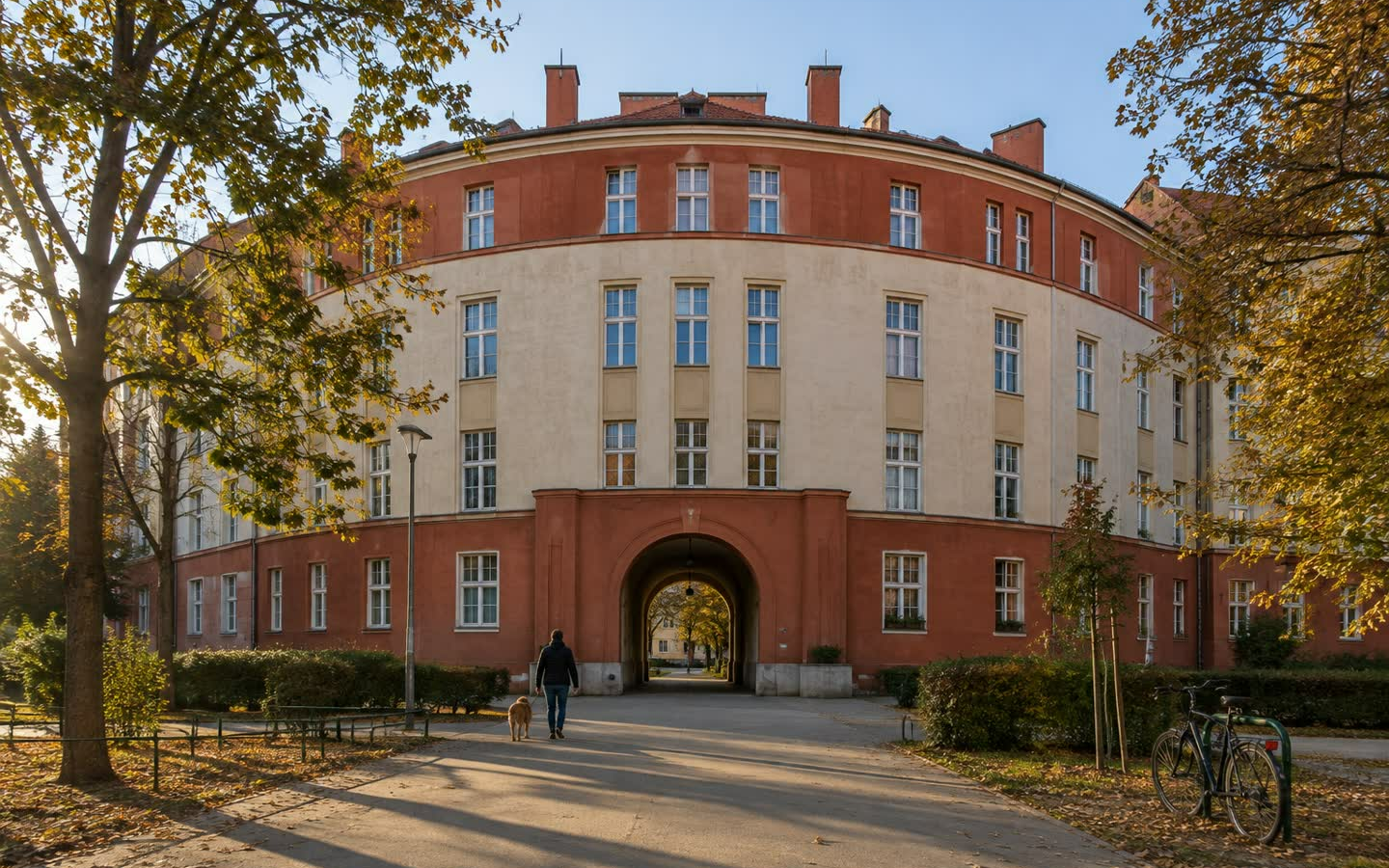 A municipal apartment block in Vienna, seen from the street in late afternoon light (illustration)