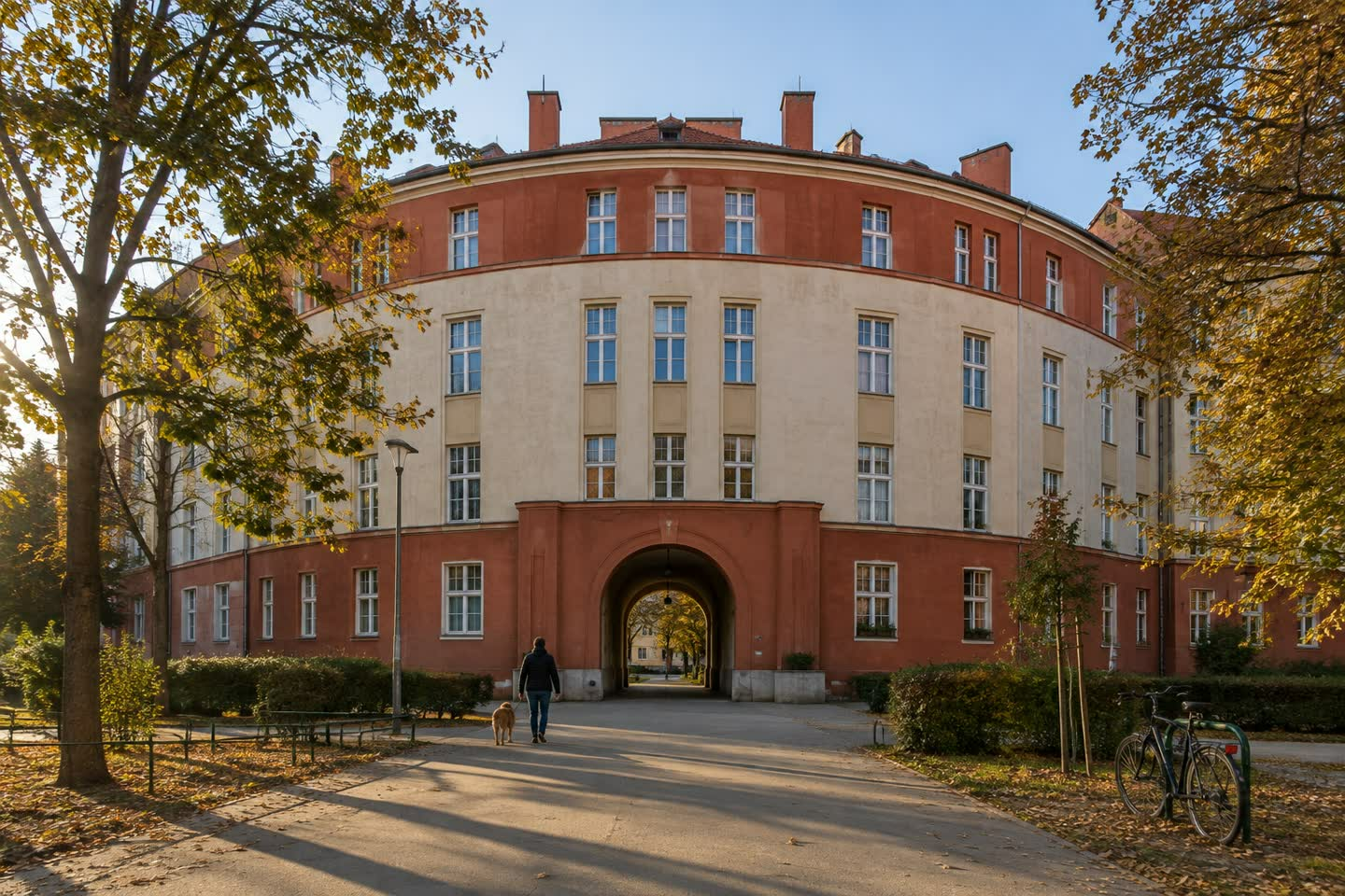 A municipal apartment block in Vienna, seen from the street in late afternoon light (illustration)