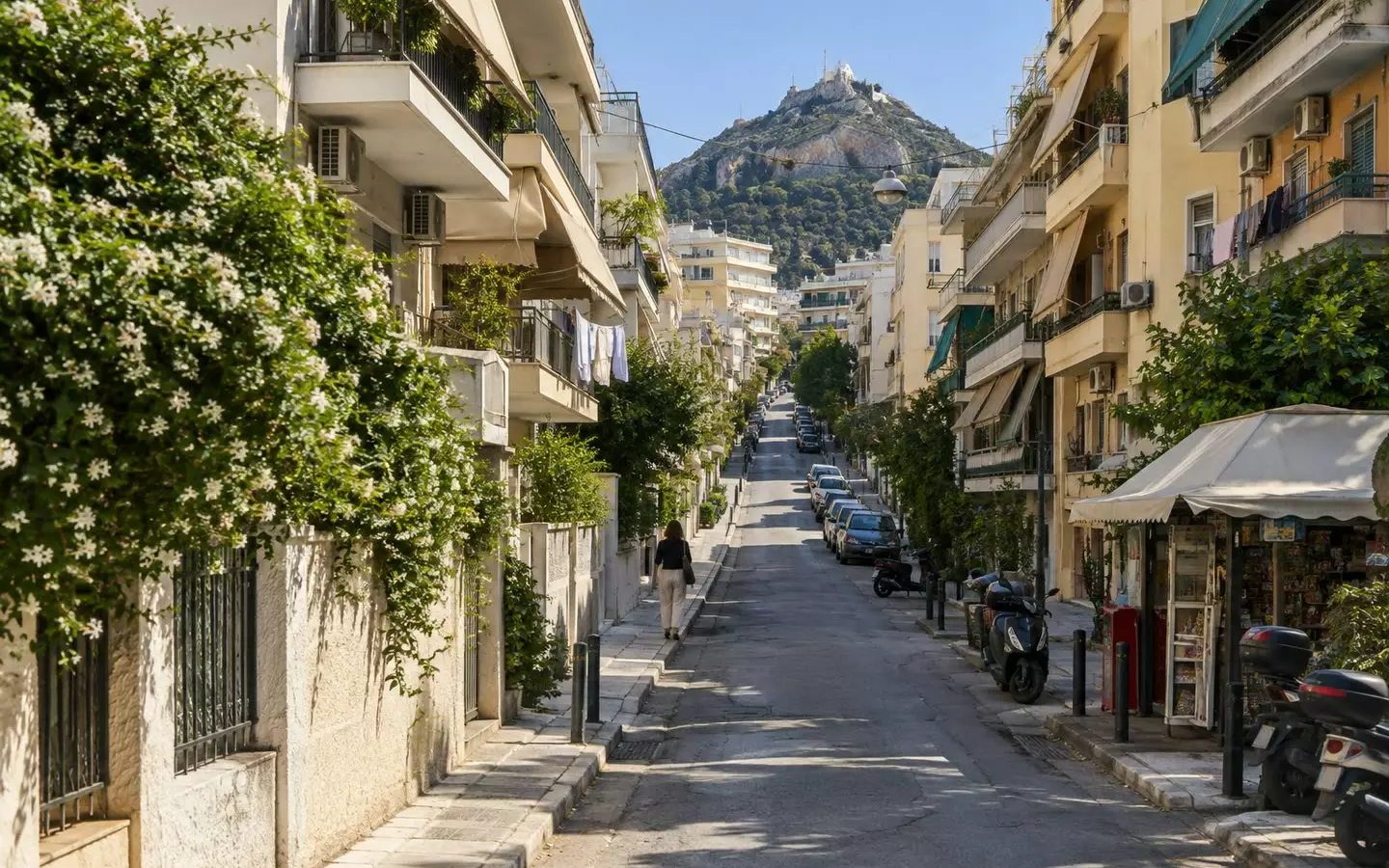 A rising Athens street of 1960s apartment blocks with balconies and awnings (illustration)