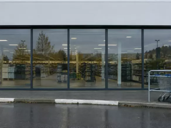 The glazed shopfront and trolley bay of a big-box retail unit on an out-of-town retail park (illustration)