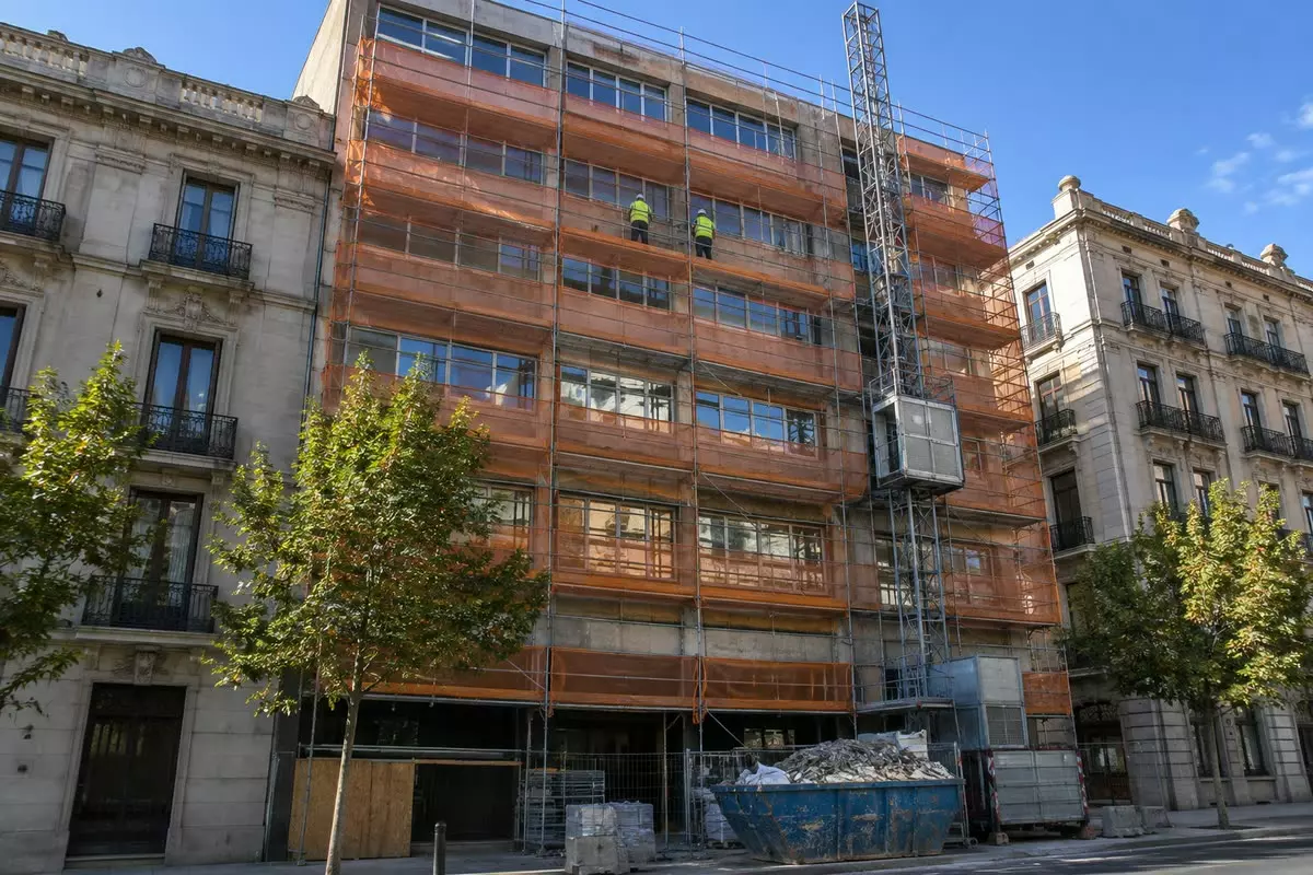 A 1970s office building under refurbishment behind scaffolding in Madrid (illustration)