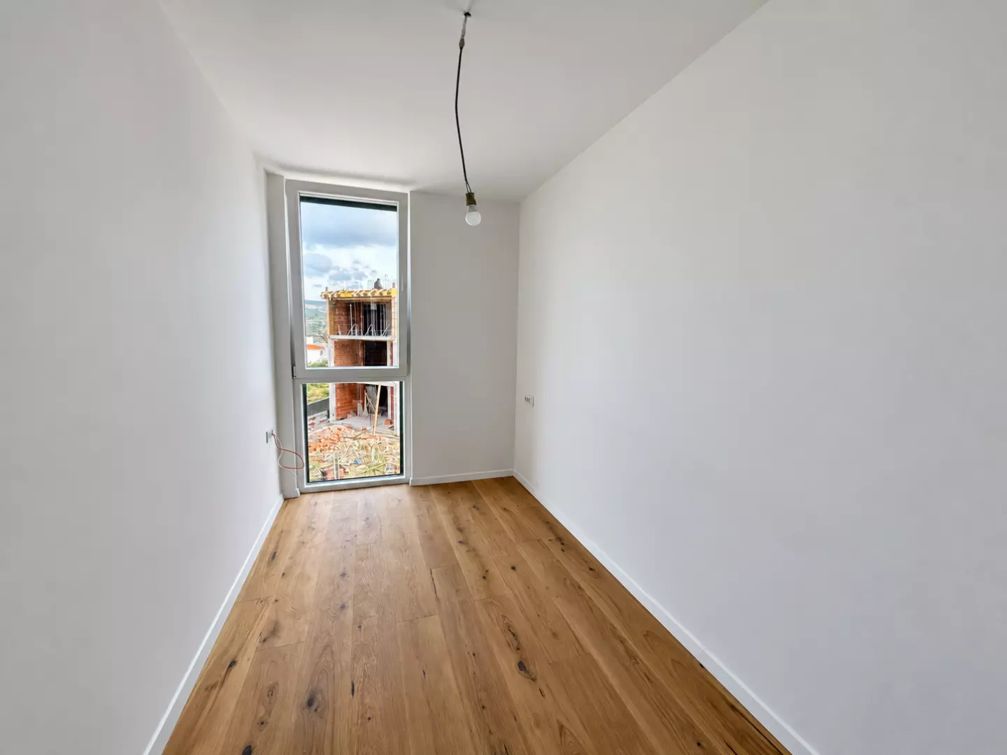 original_1791795320_empty-oak-floored-room-with-construction-view-354c04 2-bedroom Apartment In Rogoznica, Croatia (59,7 M²)